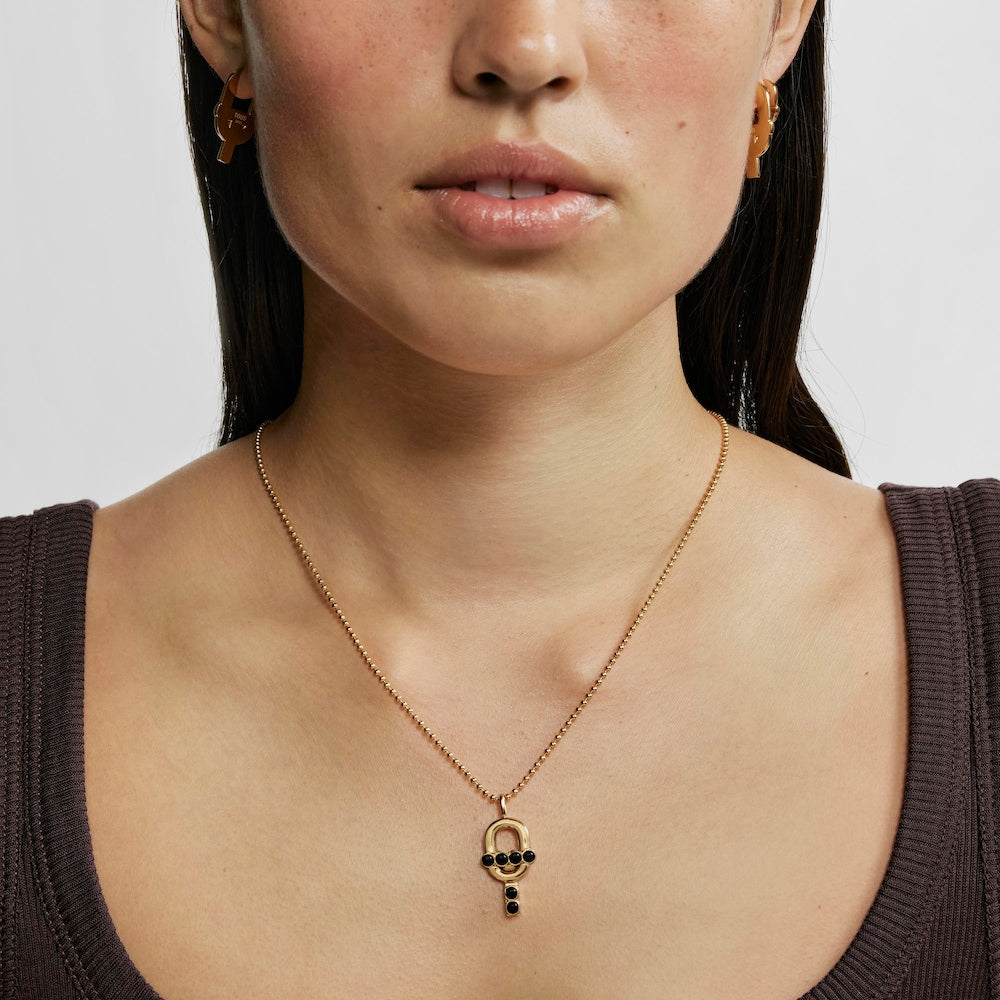 Pendant with 18kt gold plating over silver and onyx MANIFESTO